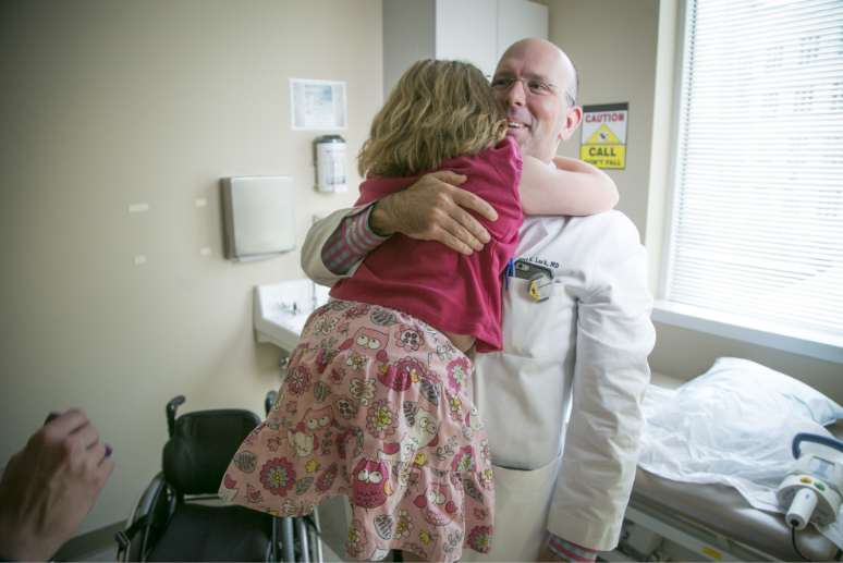 Girl hugs doctor