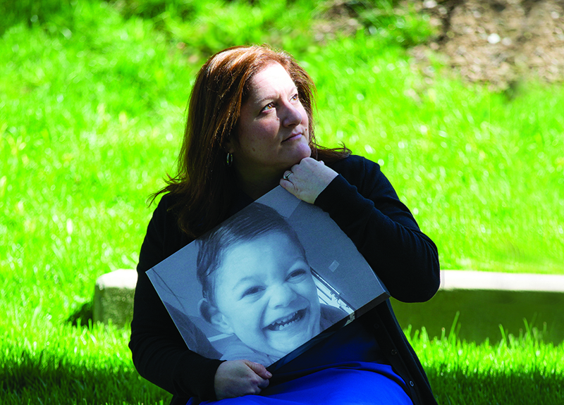 Stacy holds a photo of her son, Ryan