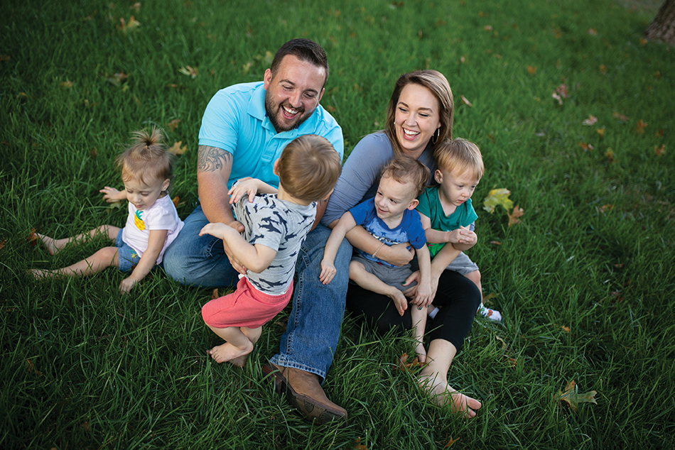 A family on a field enjoying a picnic