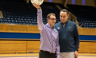 Coach K and a Duke Children's patient on the court at Cameron Indoor stadium.