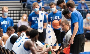 Duke Men's Basketball head coach Jon Scheyer with basketball players in a huddle during the 2021 private practice session.