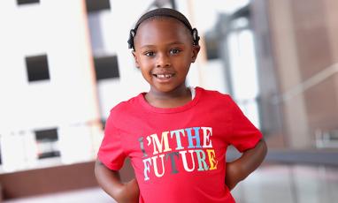 Photo of Anthony Staton, a 4-year-old Black boy in a red t-shirt. Anthony has cochlear implants.