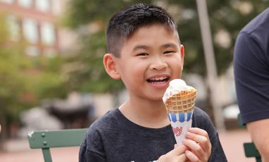 Photo of Zach, a 9-year-old Asian boy, eating an ice cream cone.