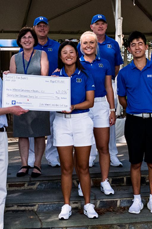 A check presentation featuring members of the Duke Golf Teams and pediatric care providers. 